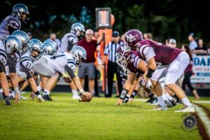 Henderson County High Football team ready for defense as the opponents prepare to hike. Photo by: Thru-a-lens photography