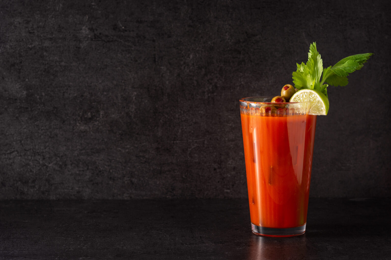Bloody Mary cocktail in glass on black background